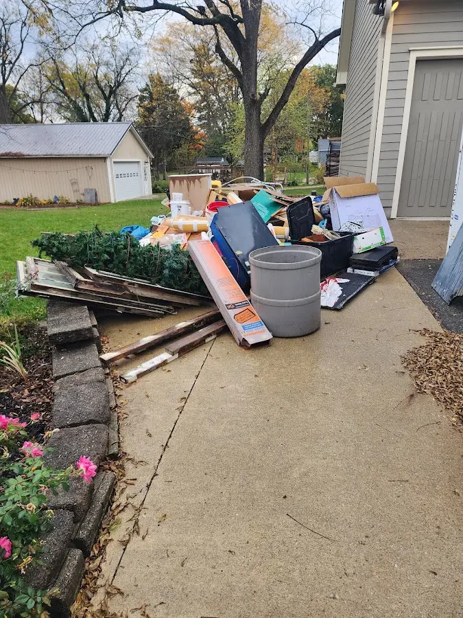 Dumpster being loaded with debris for Roofing Dumpster Rental in Coopersville